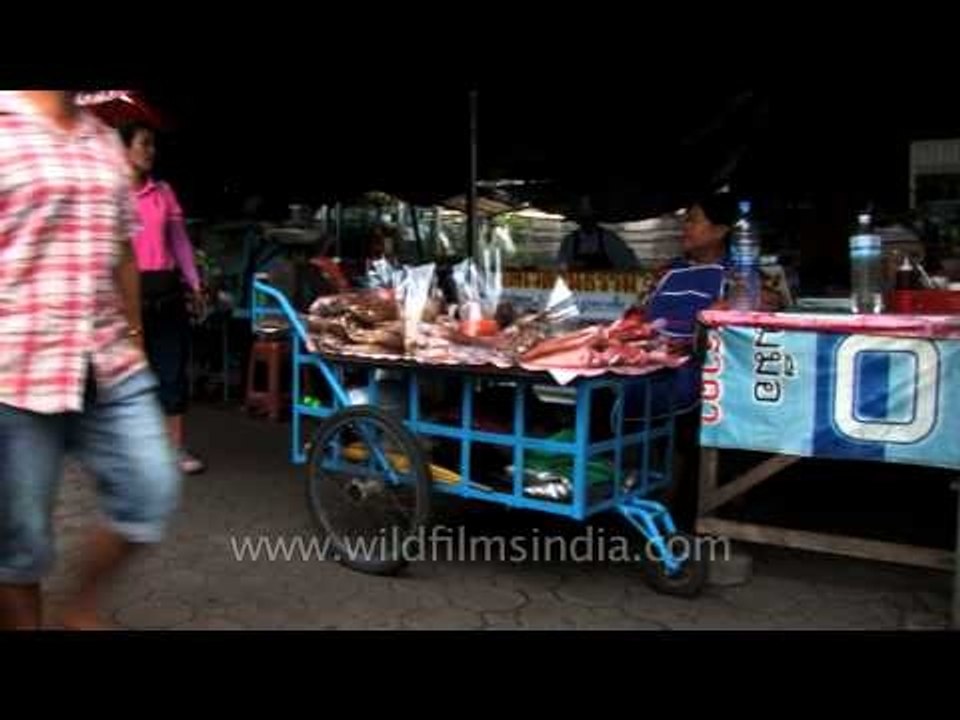 Woman selling dried insects on the streets of Bangkok