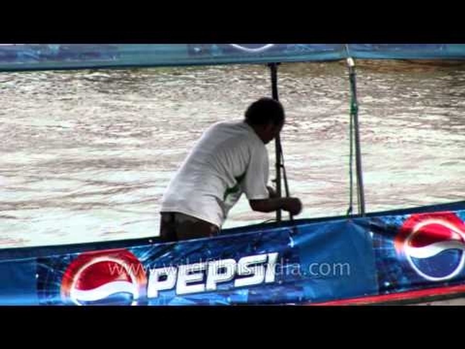 Man on longtail boat in Bangkok,  Thailand