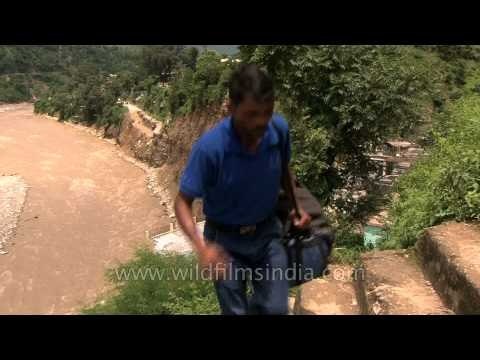 Villagers trek up from the flooded river: Uttarakhand floods