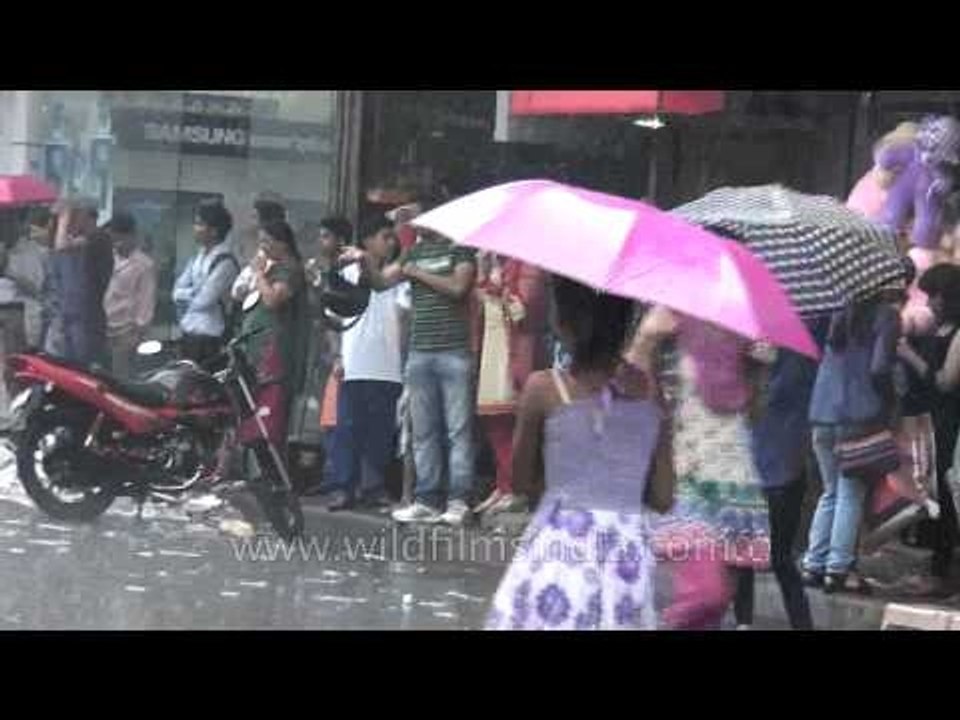 People protect themselves under the umbrella in a rainy day