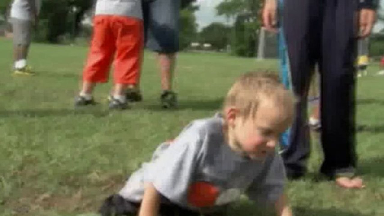 Boy without legs plays football