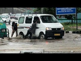 Pushing a car stuck during monsoons in Delhi