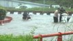 Vehicles crawl through flooded roads : India's proud capital!