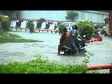 Man tries to pass through the flooded water on his bike but fails