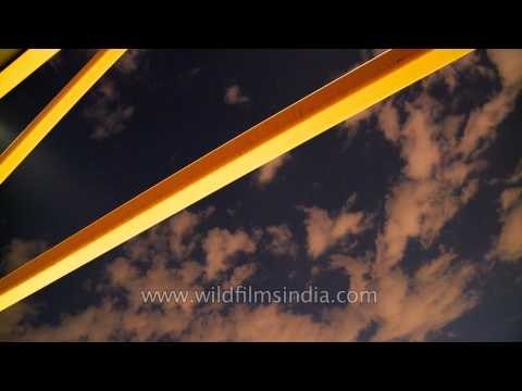 Time lapse of clouds passing by yellow bars in the continental US