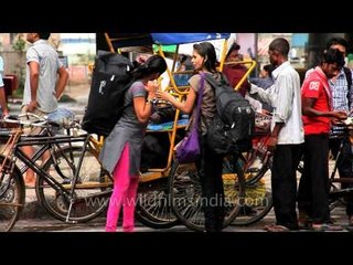 Girls with heavy baggage at the MG road Station