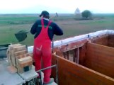 Polish builders working faster throwing shovels of mortar... Great brickwork technic!!