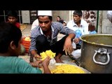 Food being packed in poly bags for distribution during Iftar at Nizamuddin Dargah