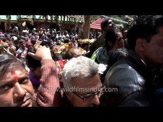 Devotees line up for just a glimpse of God