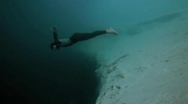 Guillaume Nery base jumping at Deans Blue Hole, filmed on breath hold by Julie Gautier