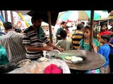 Little girl buying 'Aloo tikki' in a local fair - Agra