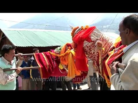 Men dancing with palanquins, woman dancing in trance at Gangotri