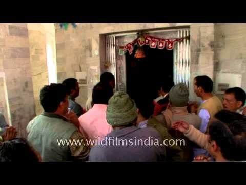 Devotees chant mantras in praise of Goddess Durga (at temple threshhold)