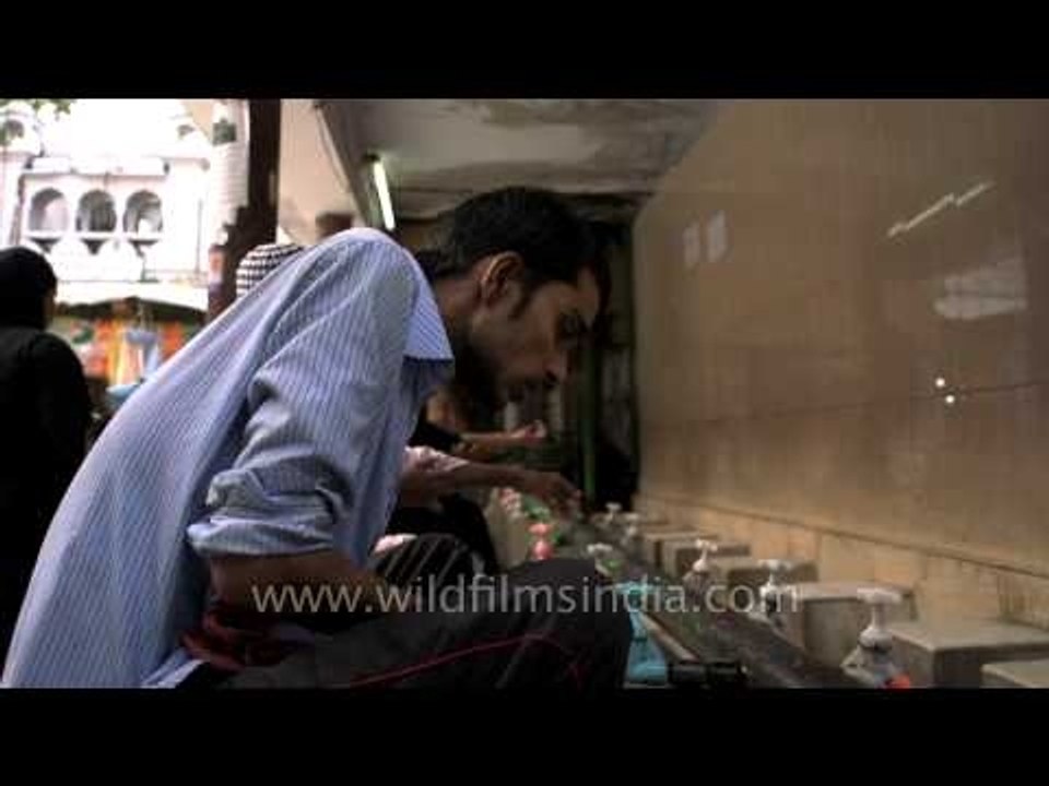 Muslim boy performing ablution before Namaz - Nizamuddin Dargah