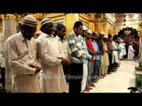 Muslims performing evening Salah at Nizamuddin Dargah