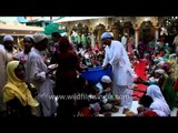 Fasting Muslims performing Iftar at the dargah of Hazrat Nizamuddin Auliya