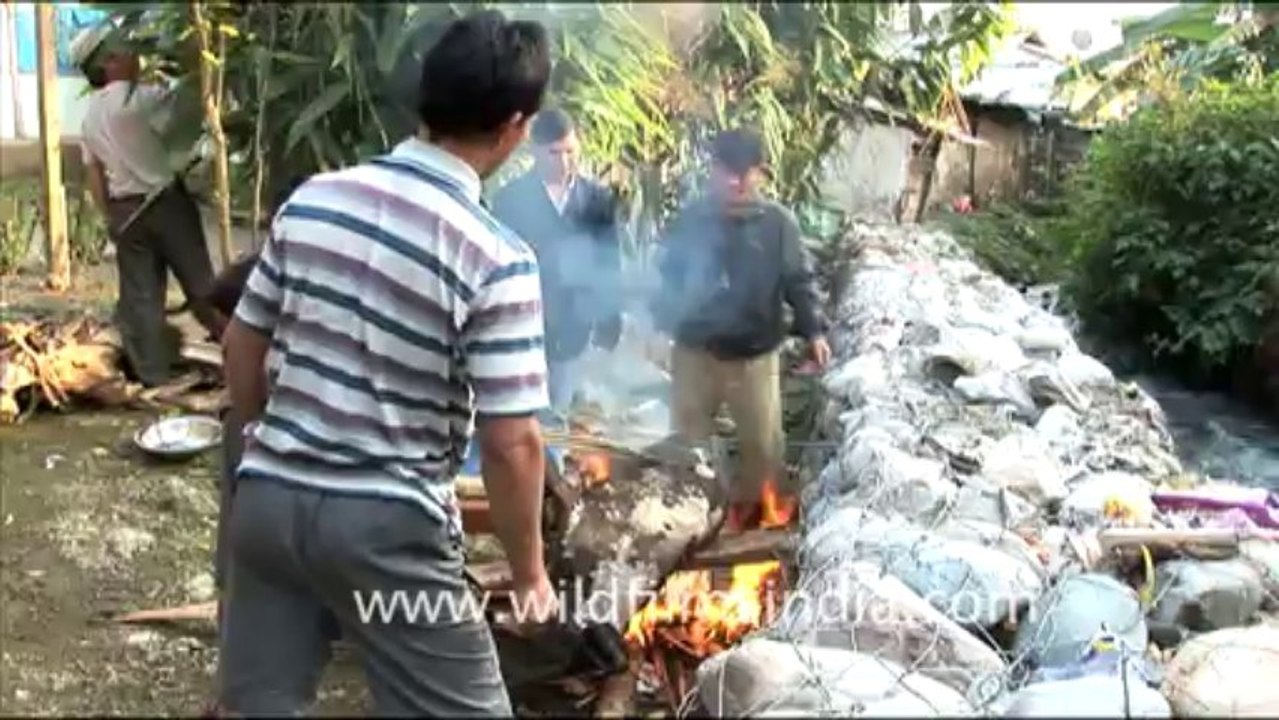 1940.Burning a pig after sacrifice in Lower Dibang valley