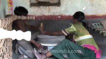 2617.Woman grinding grain with a hand mill at Nana village