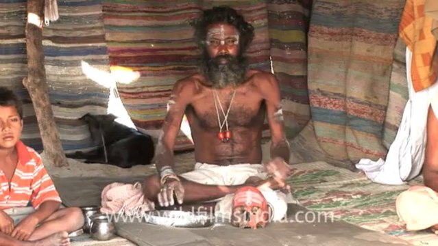 2630.Aghori sadhu with skull, applying human ash!