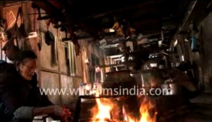 390.Apatani women cooking pig