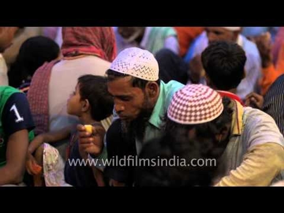 Fasting devotees performing Iftar at Nizamuddin Dargah