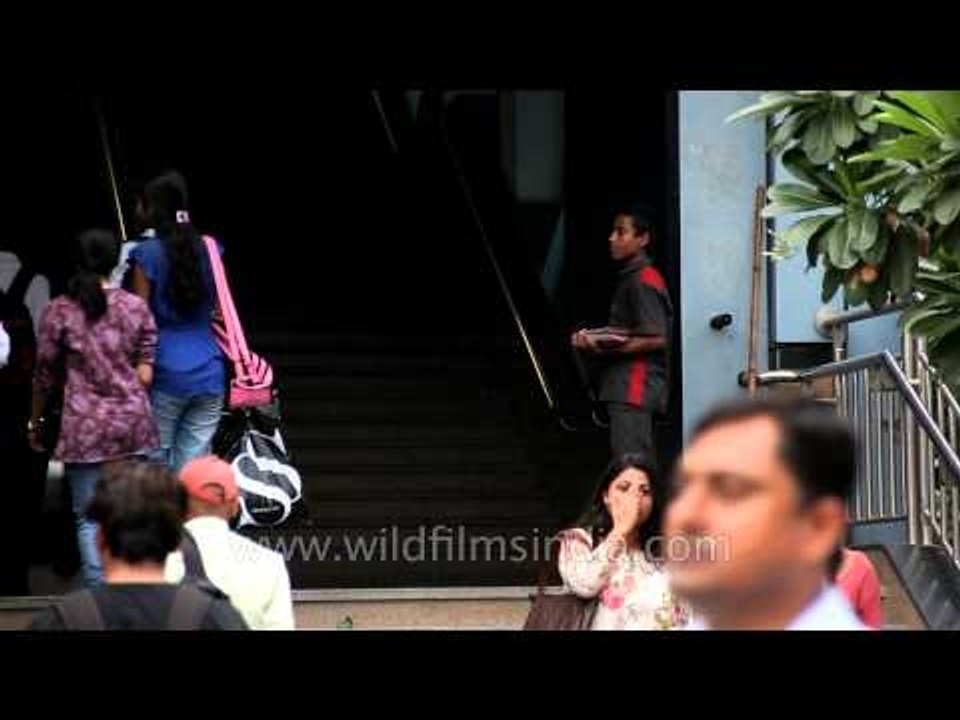 A boy distributing a leaflets at Noida sec 18 metro station