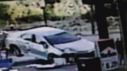 Car flip-rolls into petrol station