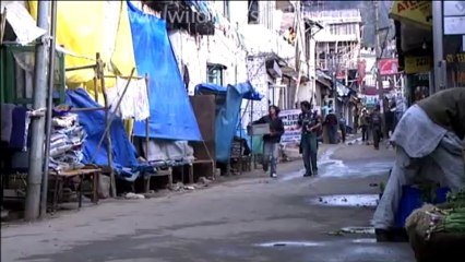 Tibetan boy washing utensils