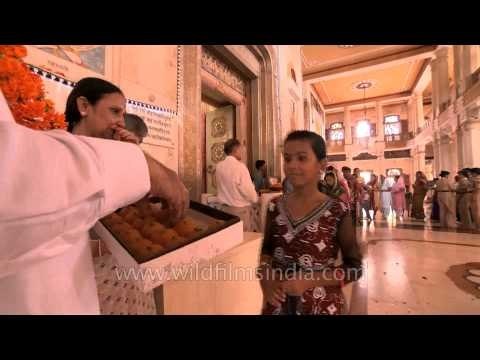 Pandit giving away the Prasad to the believers on Janmashtami