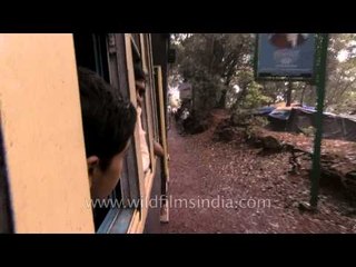 Children peep out through the train window in Matheran, Mumbai