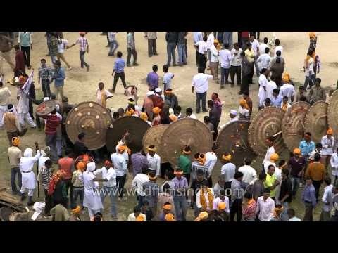 People carrying large wooden shields for Bagwal