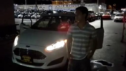 Rusty Restituto and his first car - a 2013 Fiesta at Future Ford.