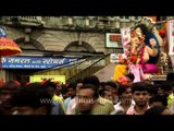 Devotees bring their deity towards the sea for immersion: Mumbai Ganpati