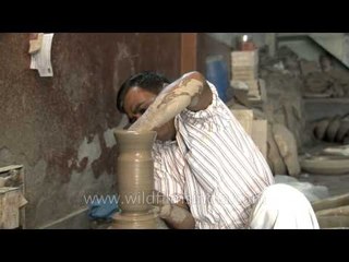 Potter concentrating on his work