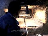 Baker baking fresh bread in oven