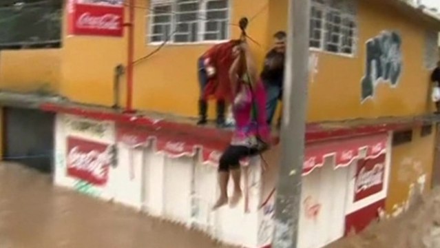 Locals use ziplines to cross Mexico's flooded roads