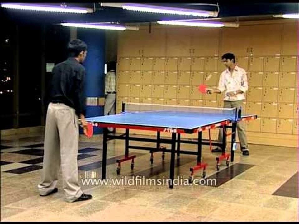 Call centre workers playing table-tennis