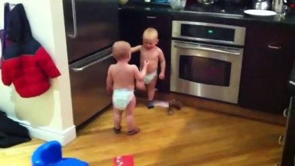 Twin baby boys having a conversation