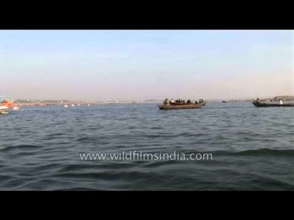 Devotees take boat ride in Sangam during Ardh K...