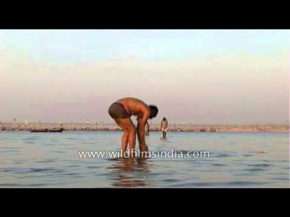 Hindu devotee performing rituals on  the Banks of Ganga at Prayaga - Ardh Kumbh Mela, 2007
