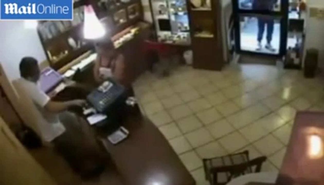 Moment a brave jeweller confronted armed bandits on CCTV