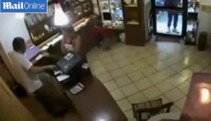 Moment a brave jeweller confronted armed bandits on CCTV