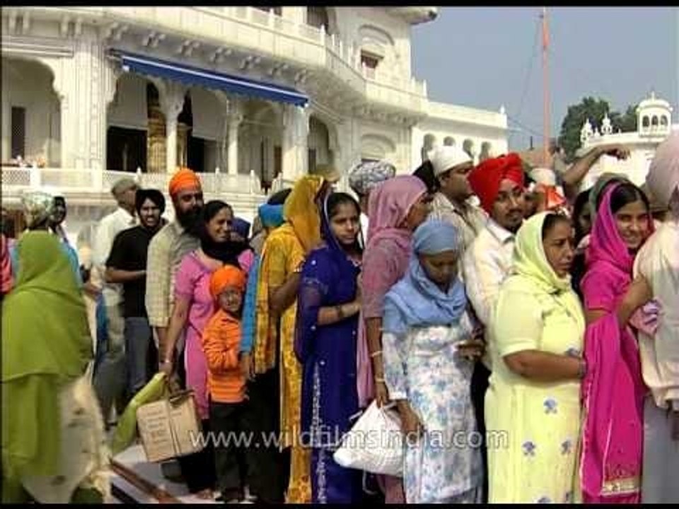 Sikh devotees pay their respects at the Sikh Shrine - Golden Temple