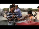 Passer-by quenching their thirst in Delhi streets