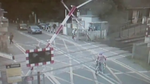 Shocking CCTV: Cyclist narrowly avoids being hit by train