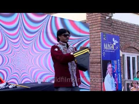 Magician on stage with varieties of tricks : at Annual Magic Fest