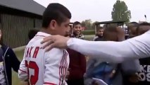 Daniel Agger gives a fan a shirt after accidentally hitting him with a ball