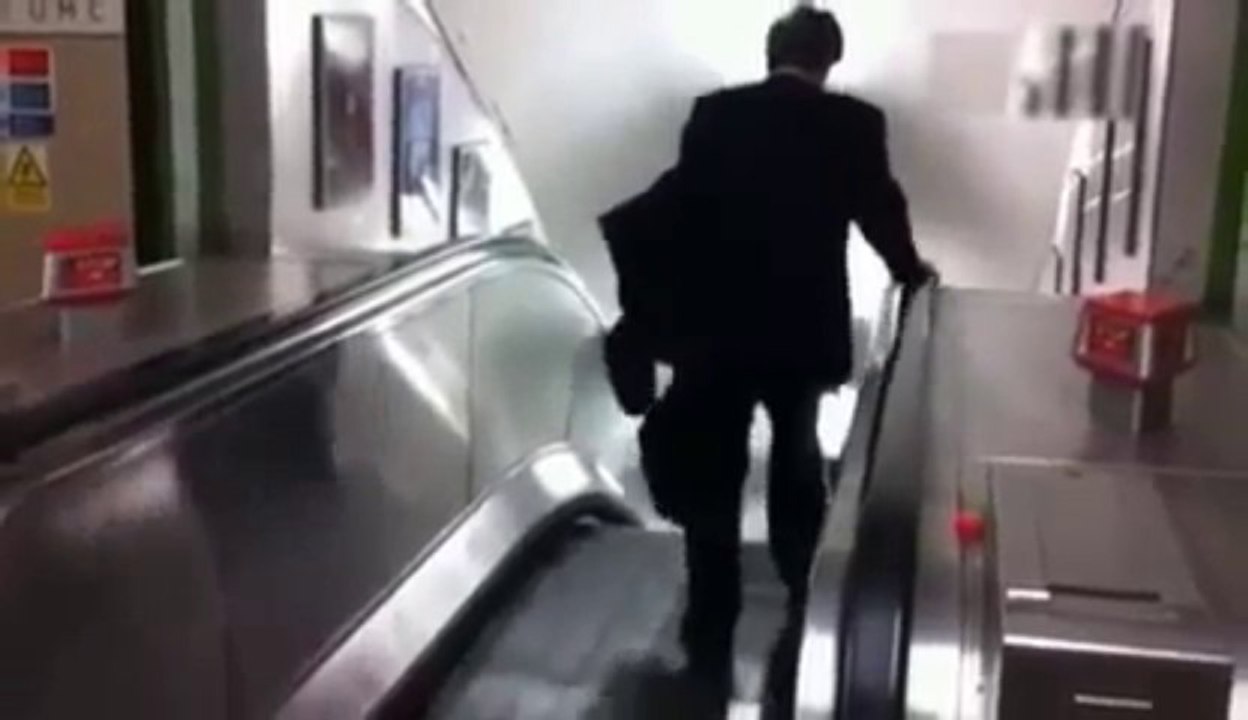 Hilarious Video Drunk Businessman Wrong Way Down Tube Escalator FAIL