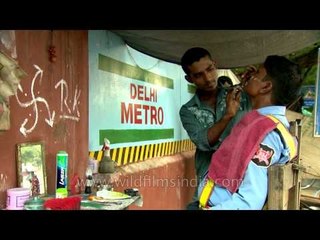 Road-side barber at work near Delhi Metro: old and new co-exist