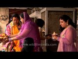 Married women taking blessings from an older woman after Karva Chauth Puja